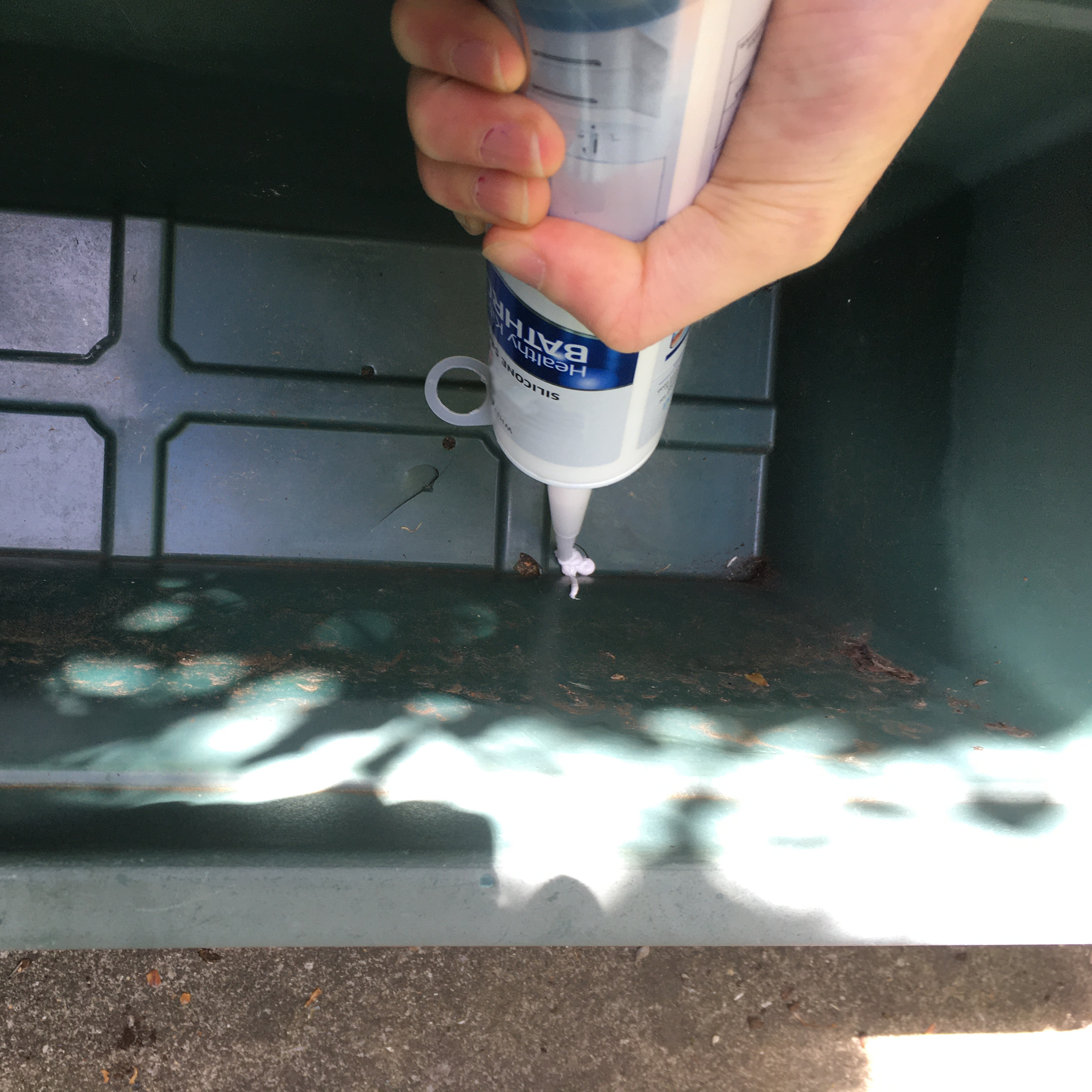 Using sealant to waterproof planter