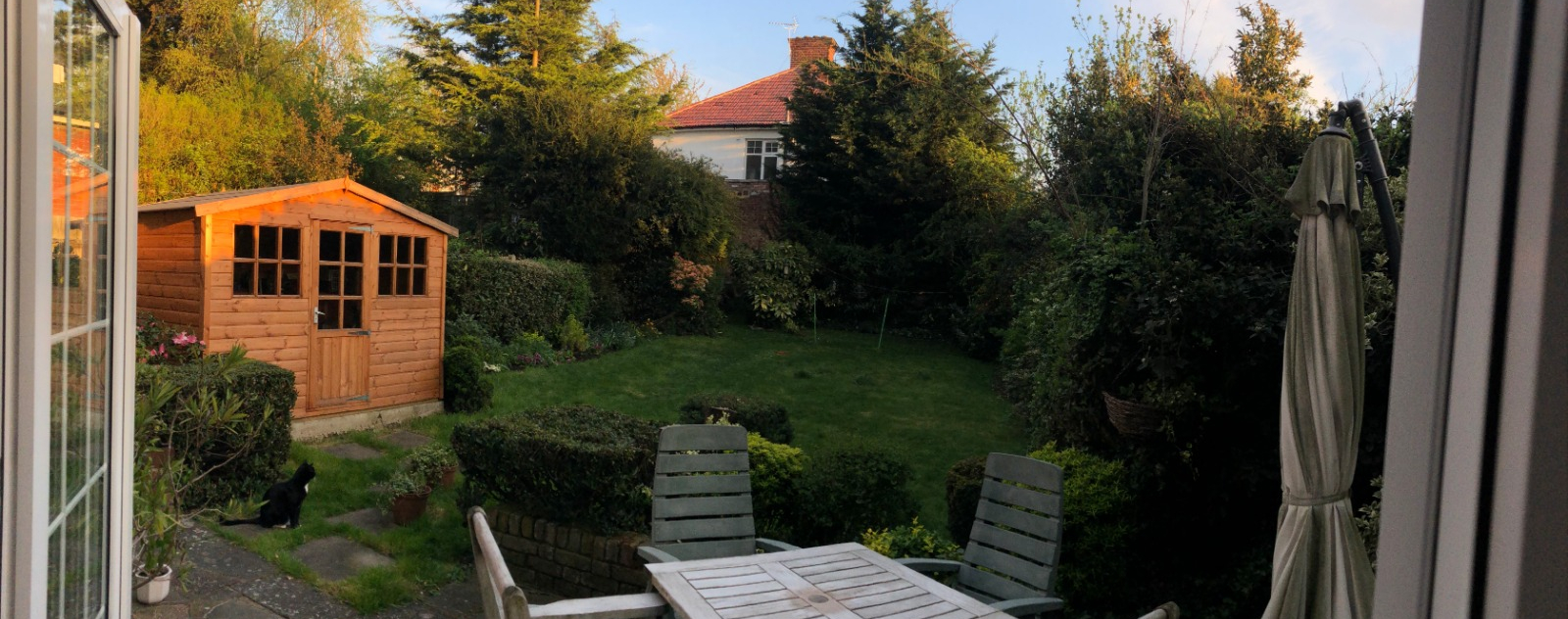 Garden with patio furniture, shed and lawn