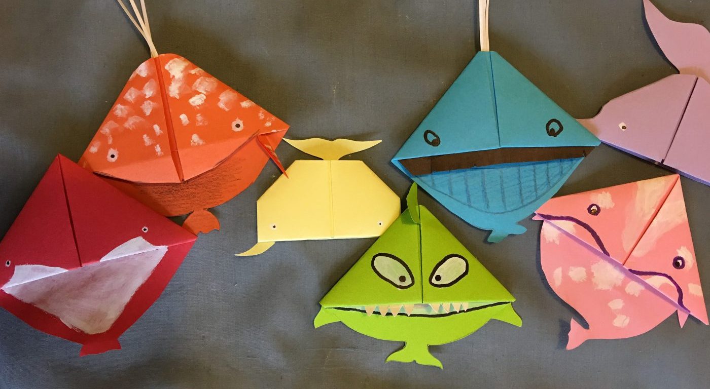 Seven whale bookmarks in different colours