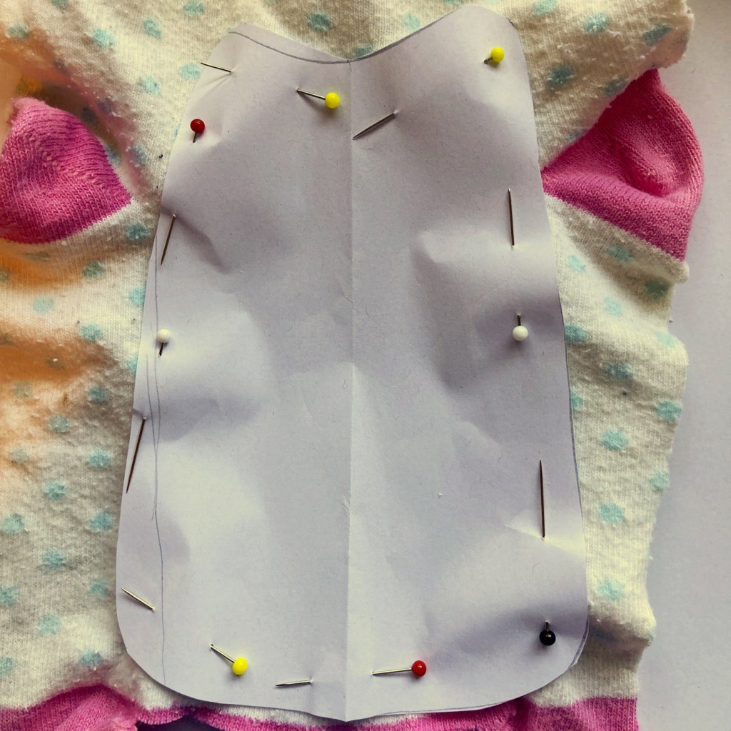 Make pattern and pin to pale coloured fabric