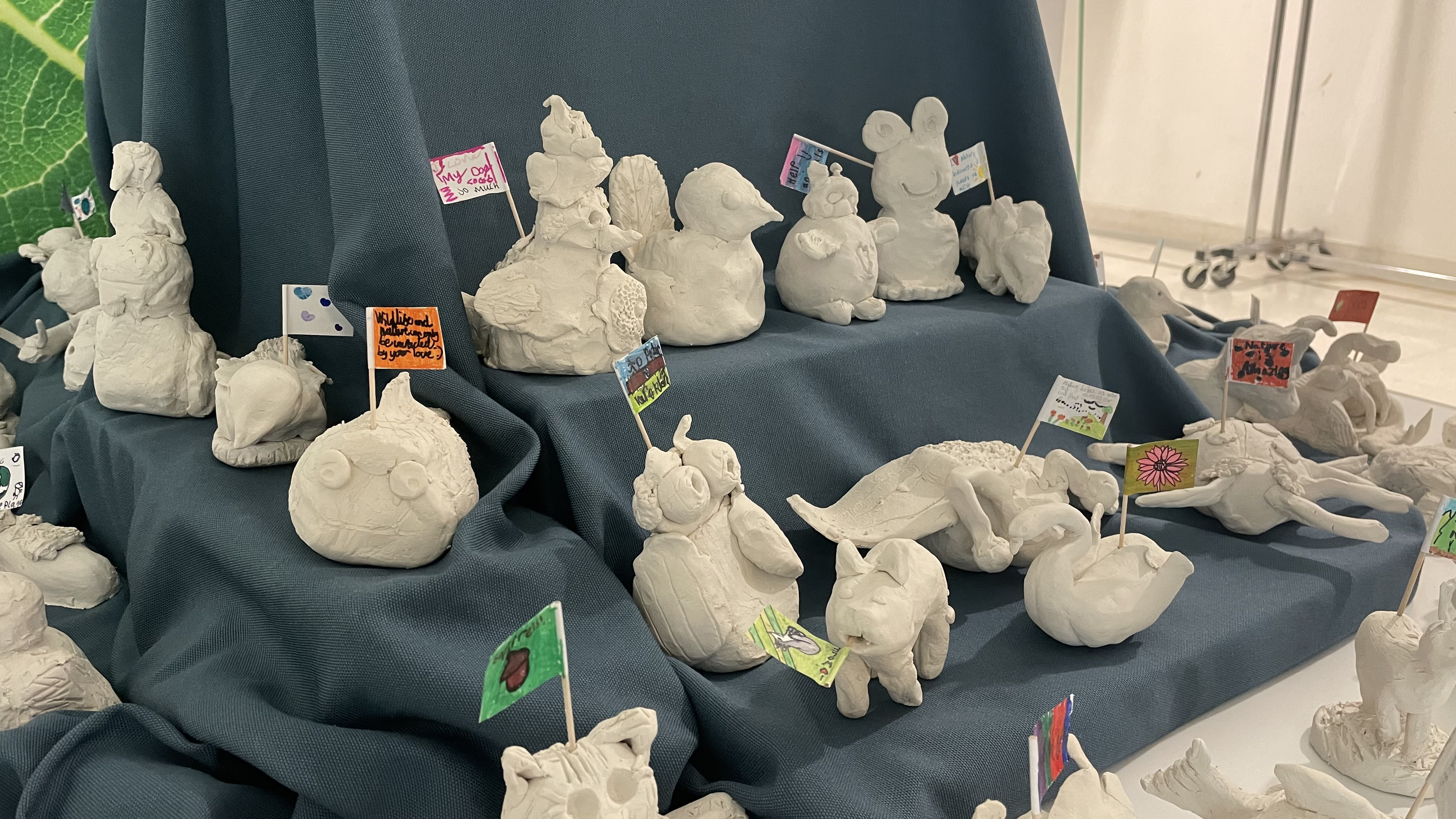 Close up of clay sculptures of animals made by school children