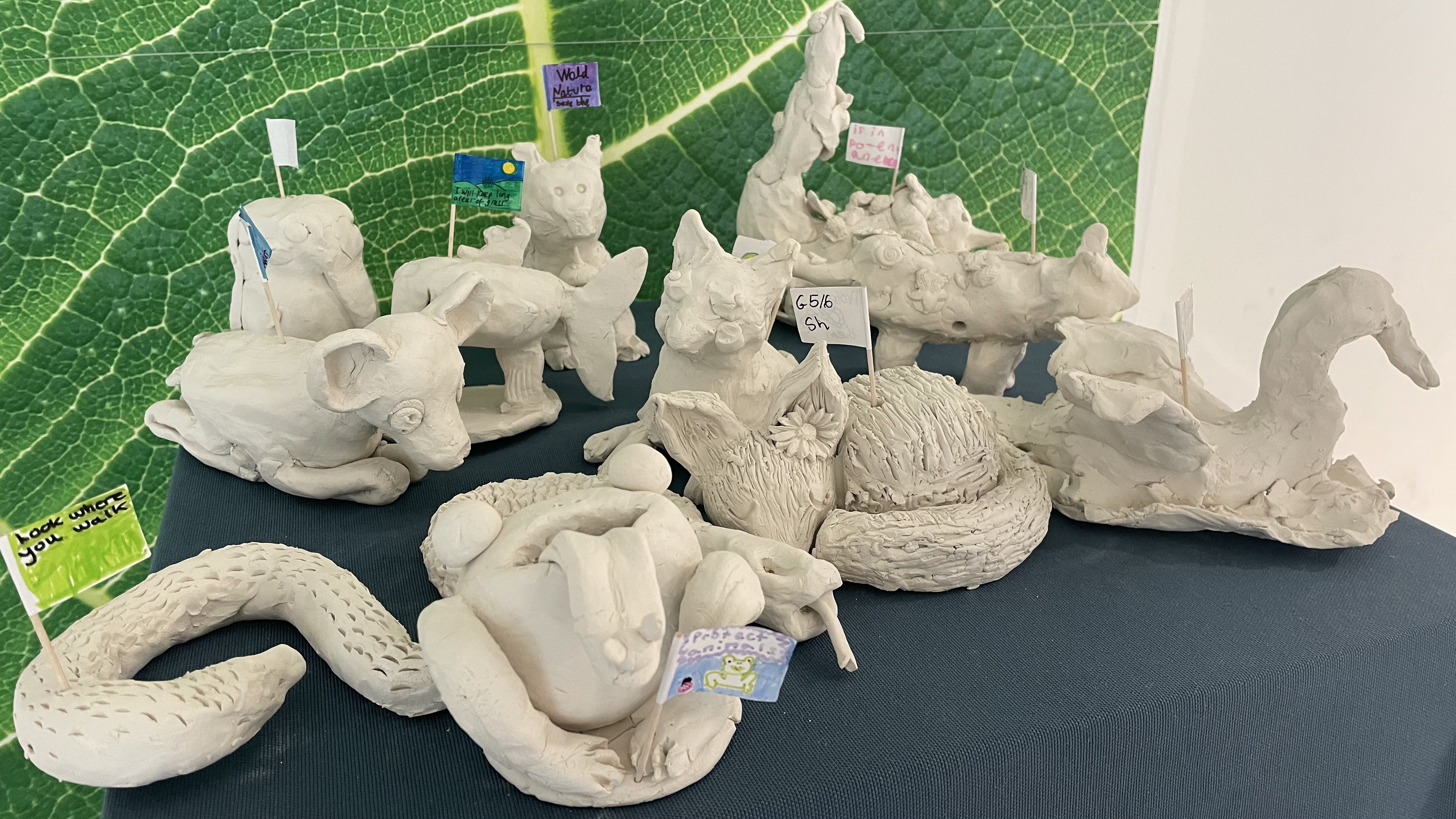 Close up of clay sculptures of animals made by school children