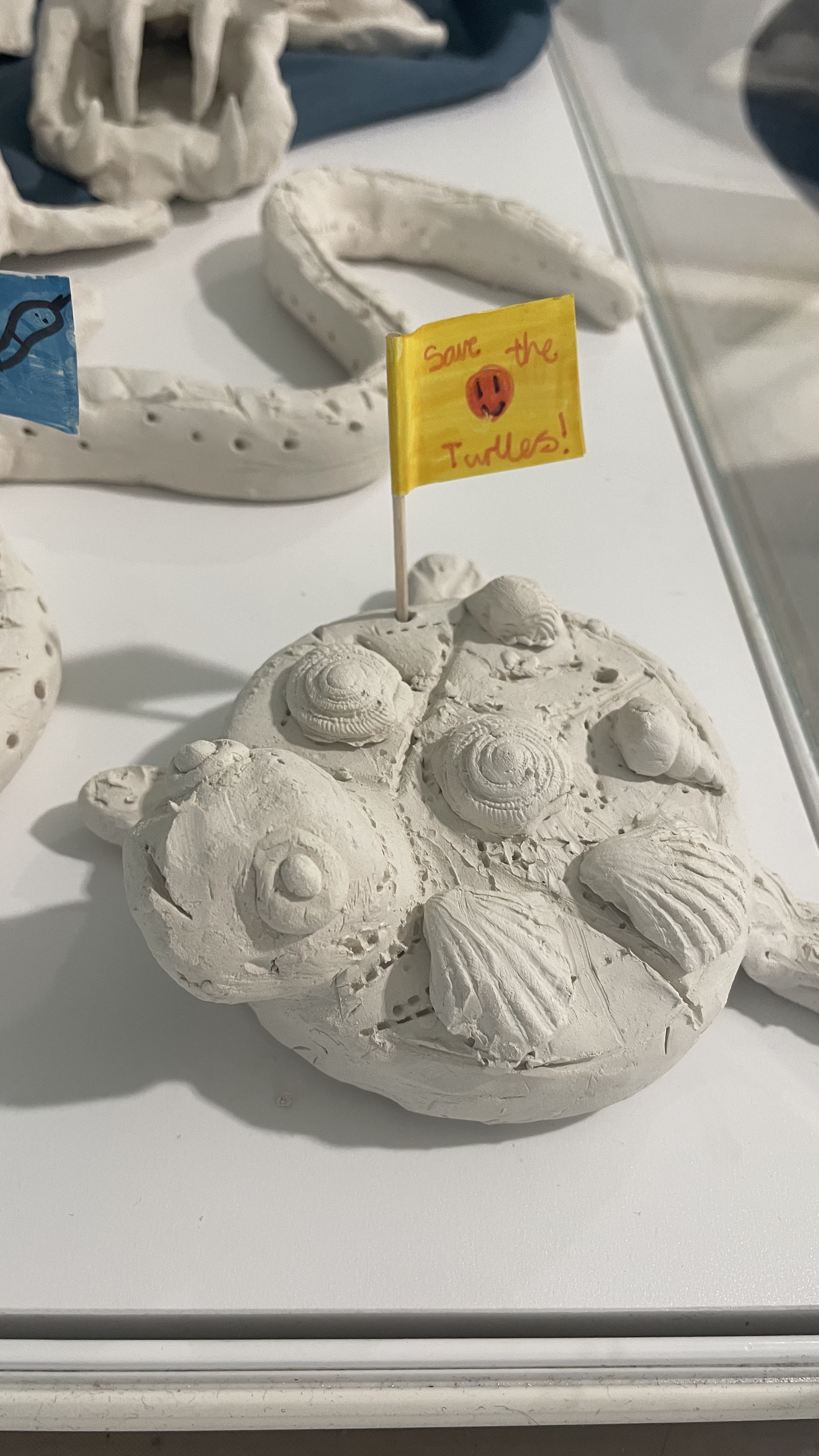 Close up of clay sculptures of animals made by school children