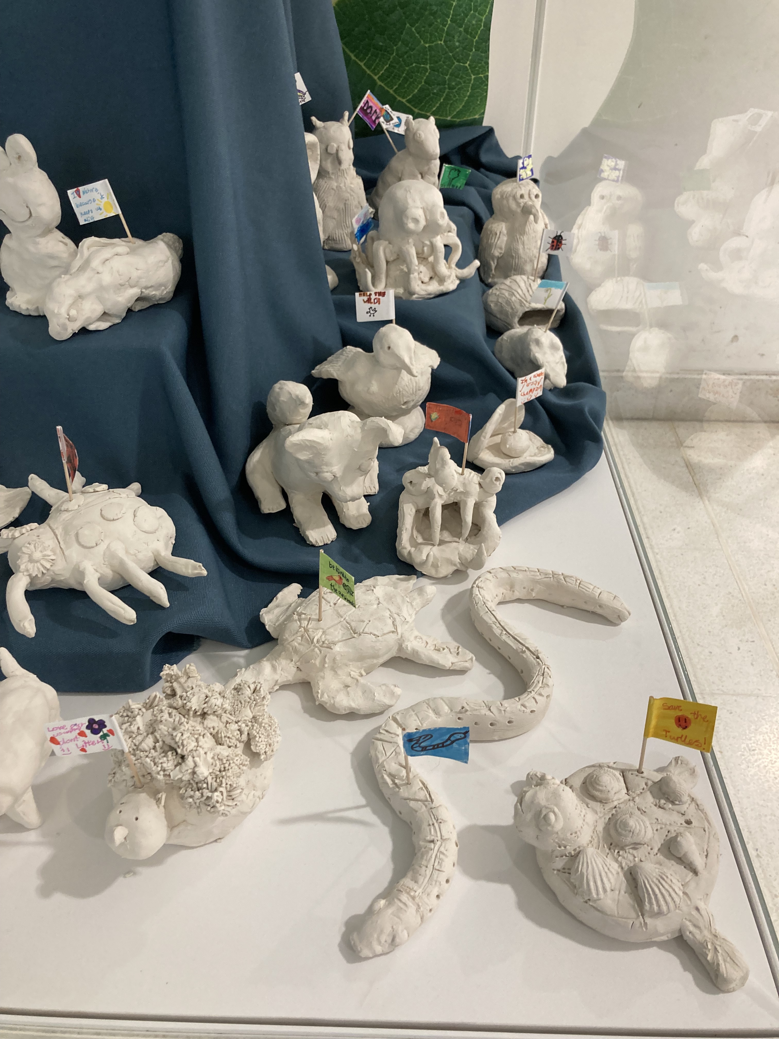 Close up of clay sculptures of animals made by school children
