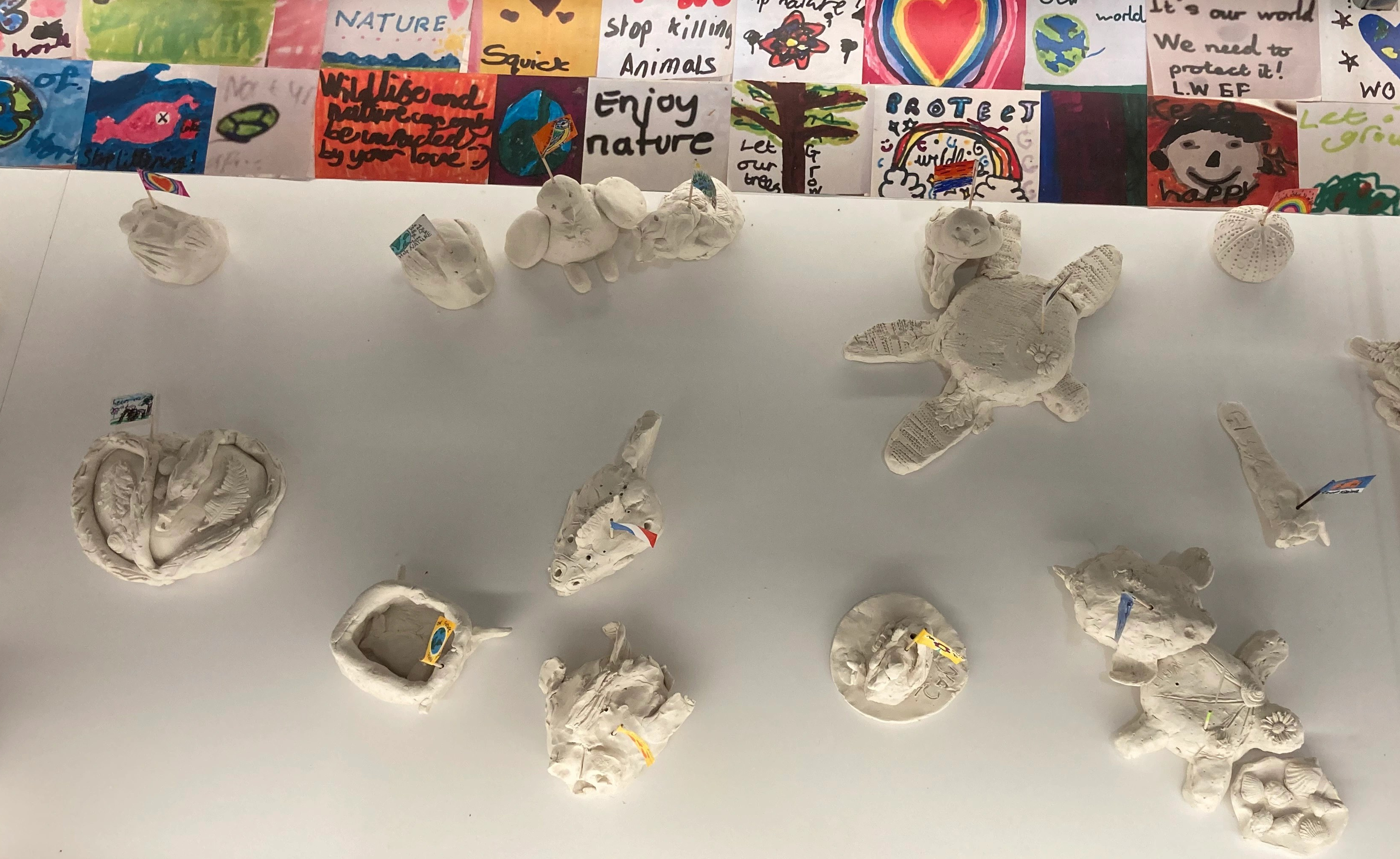 Display of clay sculptures of animals made by school children in a table case in the Museum of Zoology
