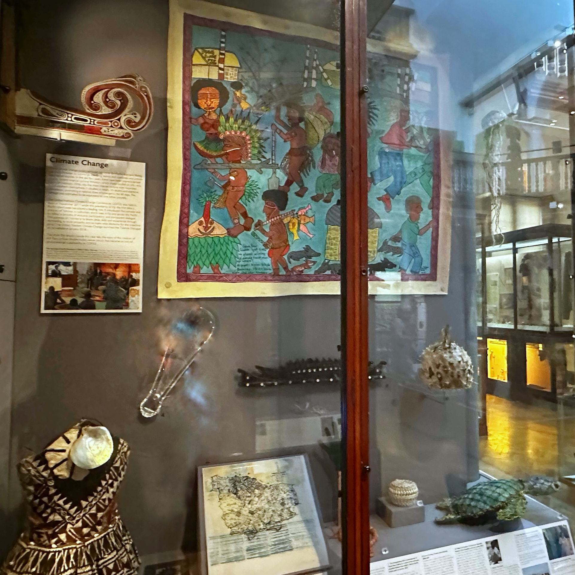 Wooded display case holding objects from Pacific islands