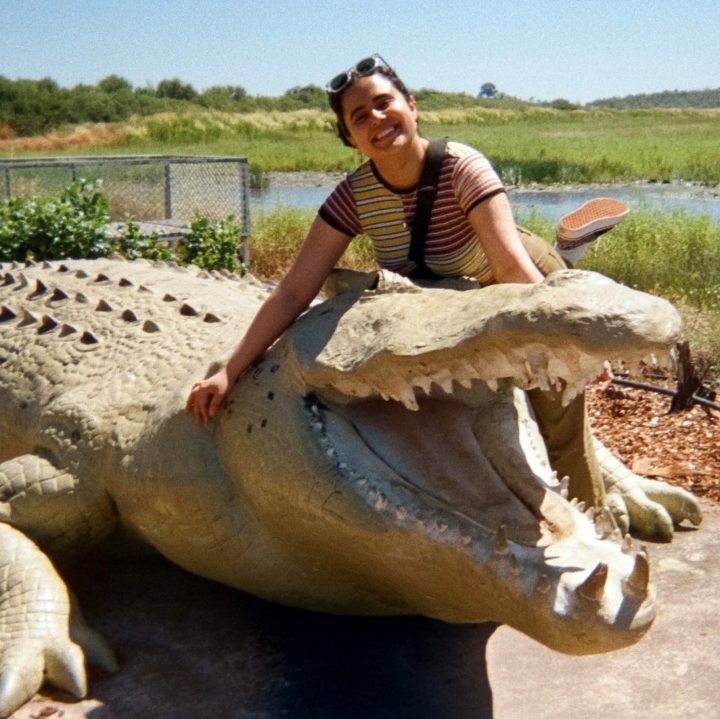 Woman with a sculpture of a crocodile