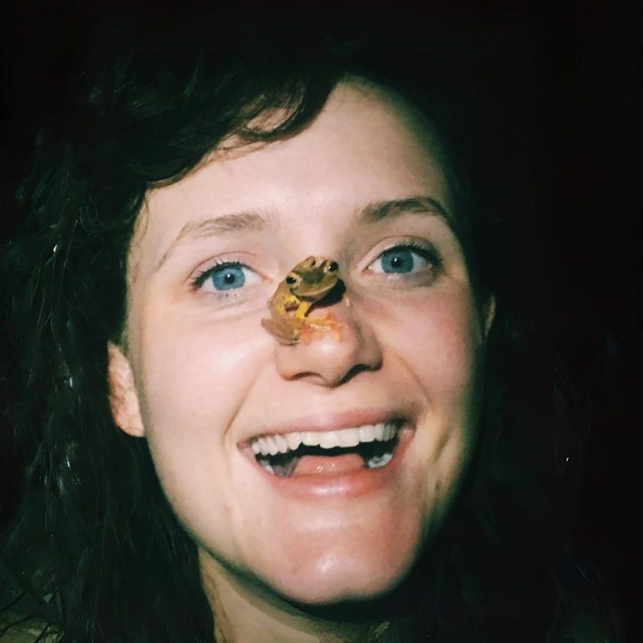 Image of a woman's face with a small frog on her nose