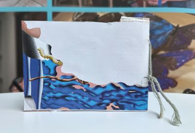 Back cover of a zine withabstract blue patterns